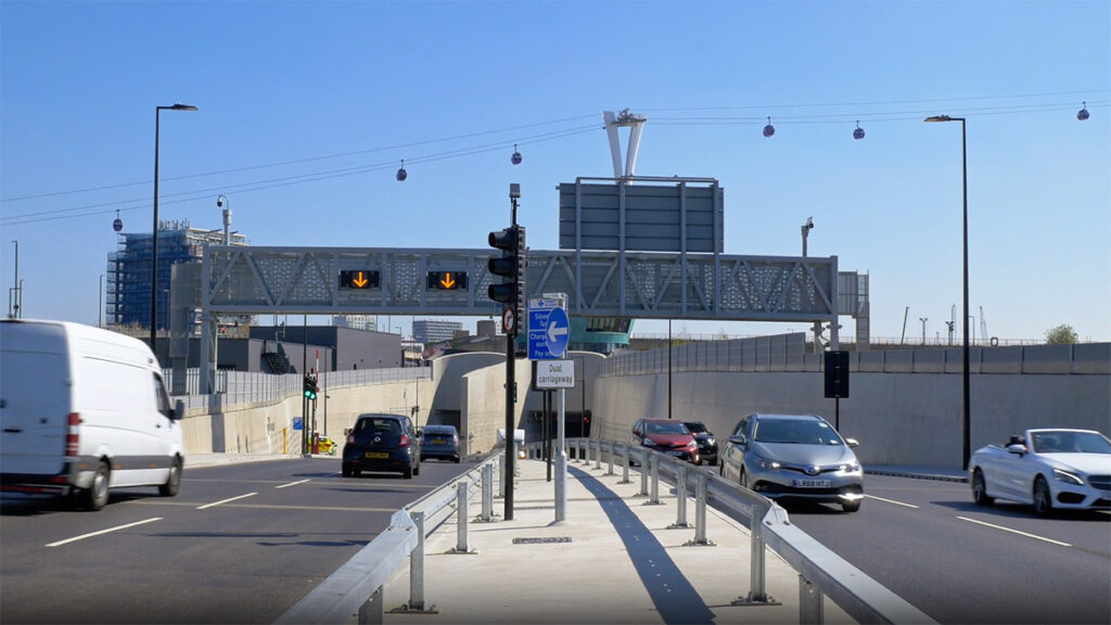 Vehicles enter and exit a tunnel in London.